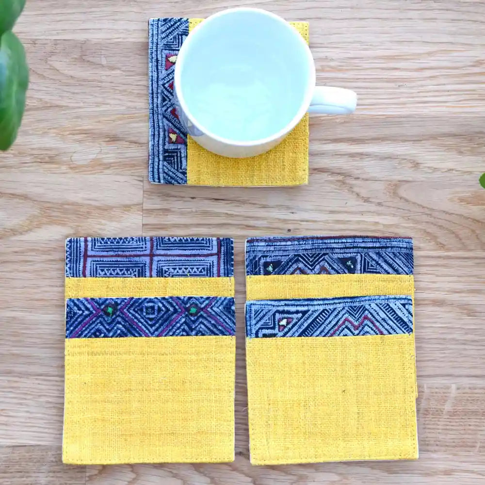 White cup placed on yellow hemp coaster with indigo pattern