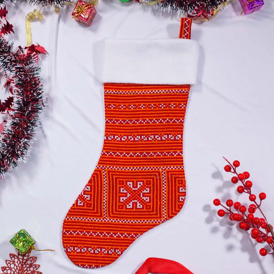 Red Nordic-style stocking with white cuff, flat lay