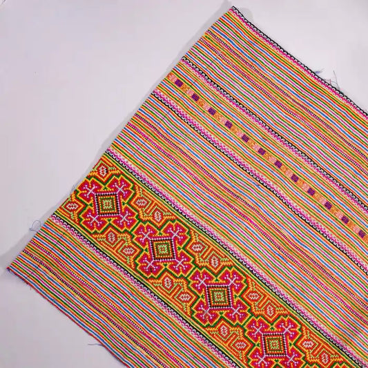Vindigo orange cotton fabric roll with tribal embroidery and stripes front view