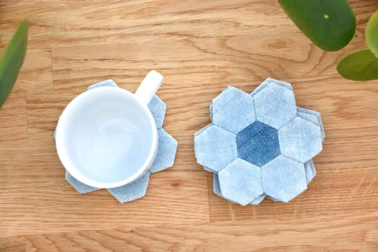 White cup placed on handmade blue denim hexagon coaster