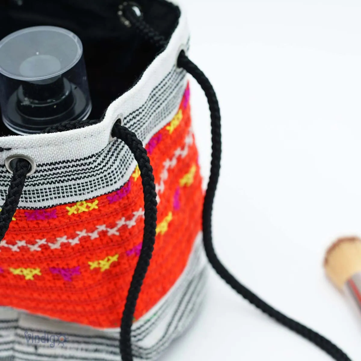 Vindigo red tribal pouch top view with black cord and accessories
