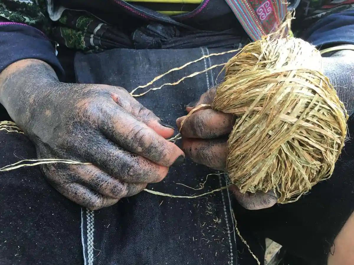 Vindigo artisan hand-preparing hemp yarn for weaving