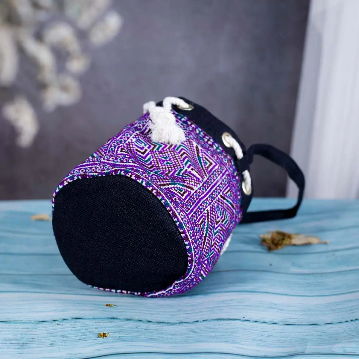Bottom angle of Vindigo purple hemp geometric bucket bag on table