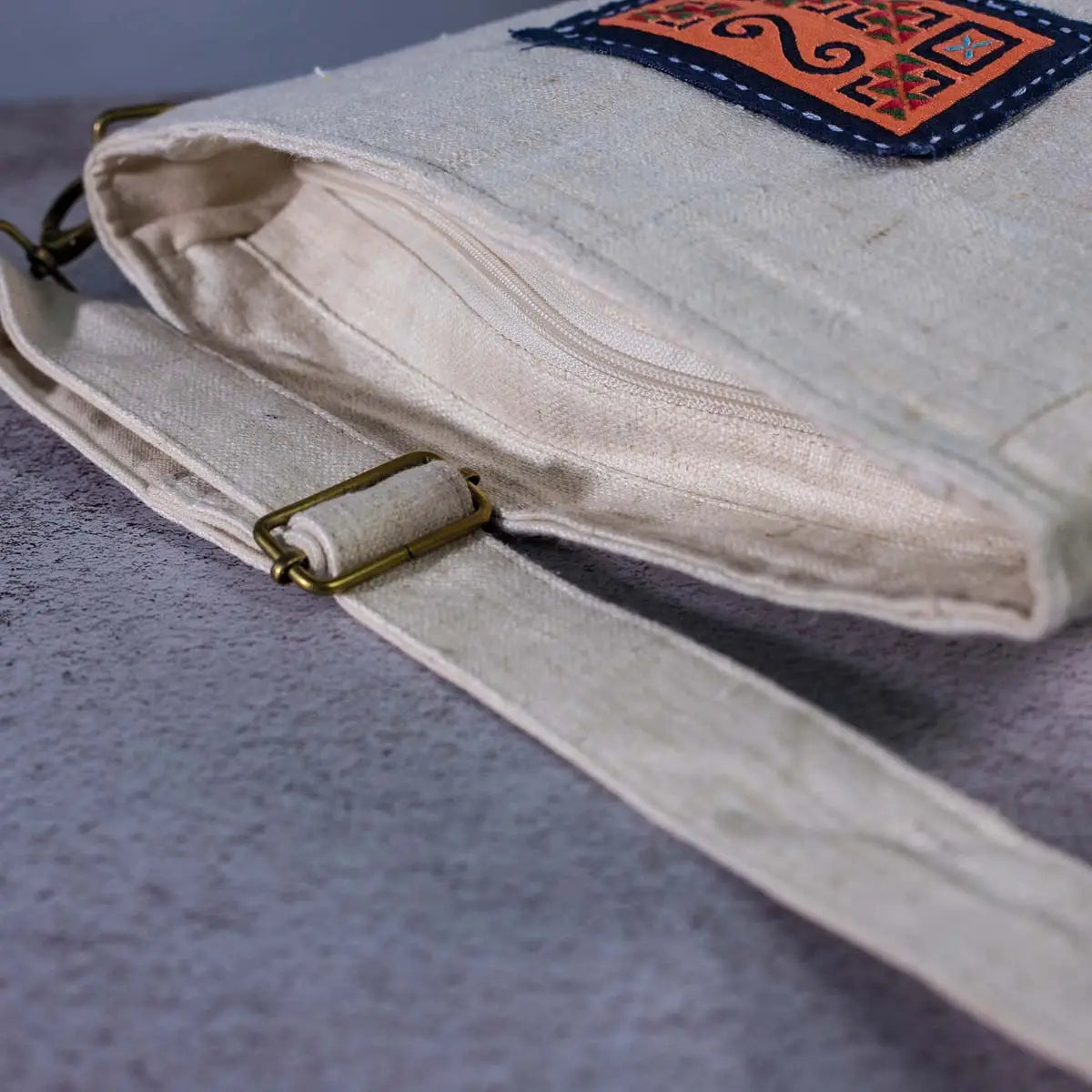 Vindigo hemp crossbody bag adjustable strap and patch detail close-up