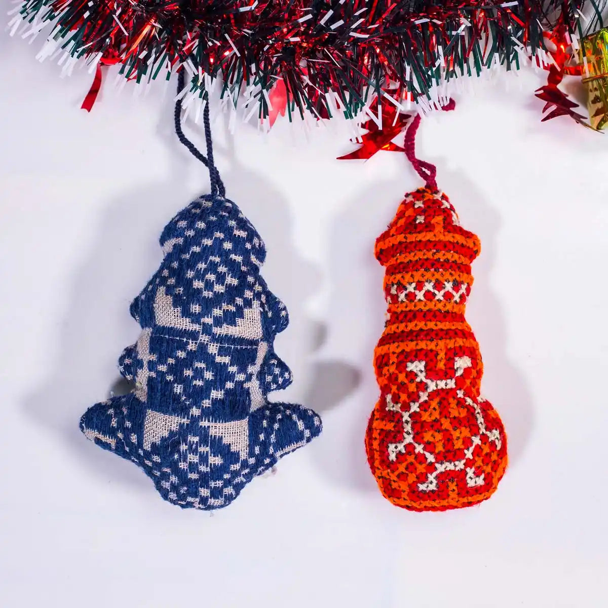Vindigo blue and red tribal embroidered ornaments hanging under Christmas garland