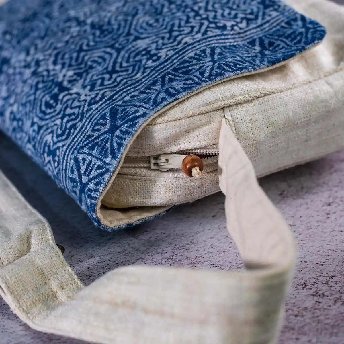 Vindigo crossbody bag close-up of indigo batik flap and wooden zipper pull