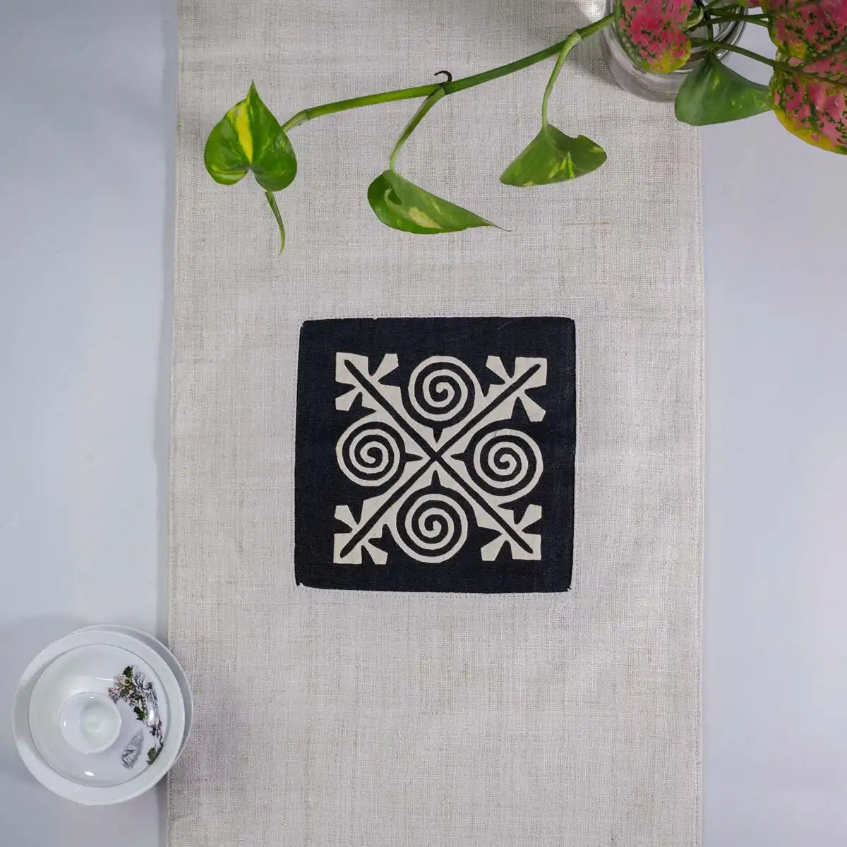 Vindigo beige hemp table runner top view showing detailed handcrafted embroidery
