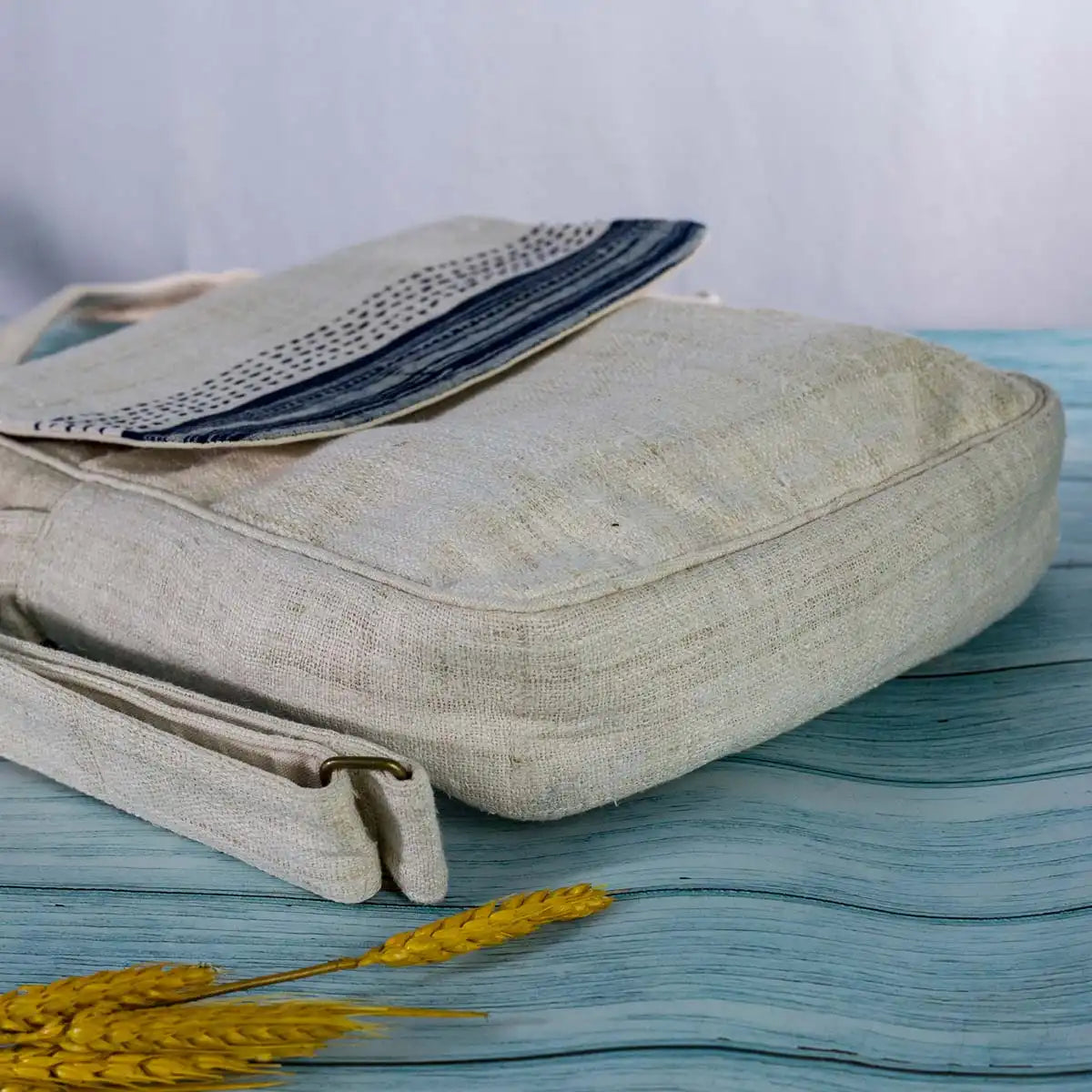 Vindigo beige hemp crossbody bag folded with indigo batik flap visible