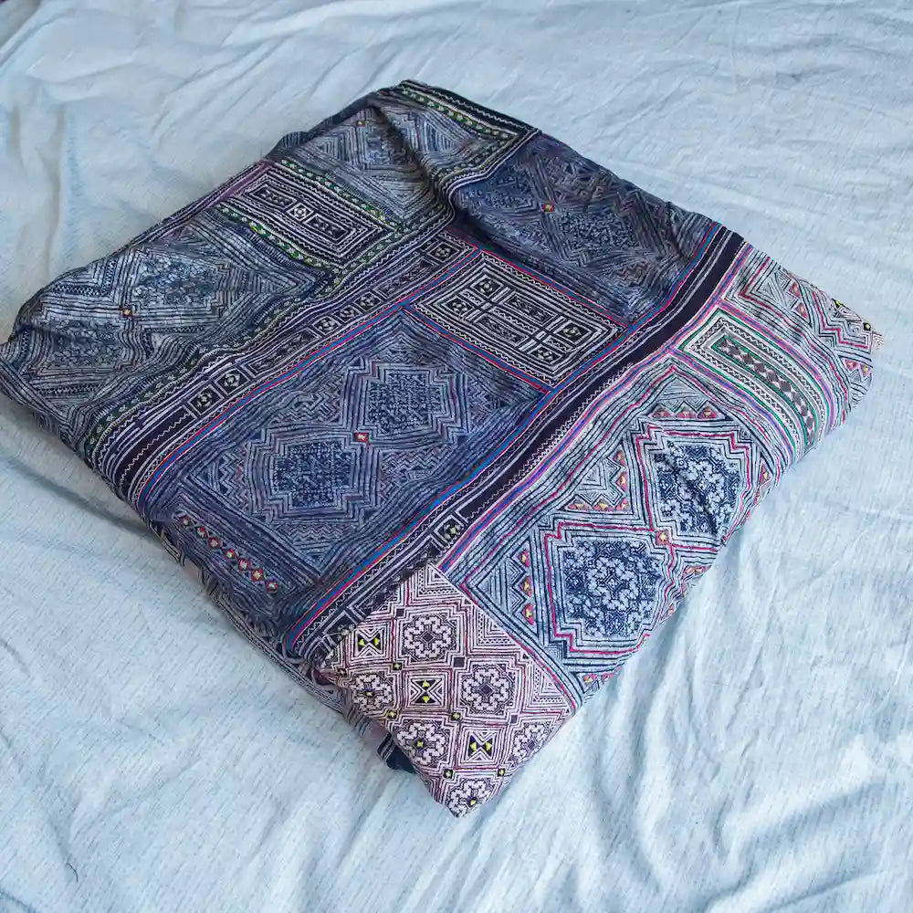 Vindigo indigo cotton bed cover with hand-drawn Hmong batik folded view
