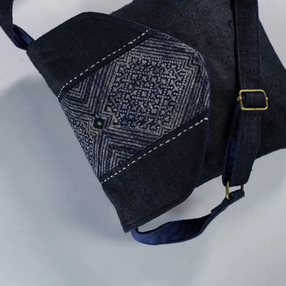 Close-up of H’Mong patch and strap detail on black hemp crossbody bag, eco-friendly handmade design