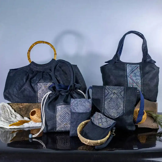 Black hemp phone bag with H’Mong patch from Purity Collection, eco-friendly handmade design, displayed with other hemp handbags.