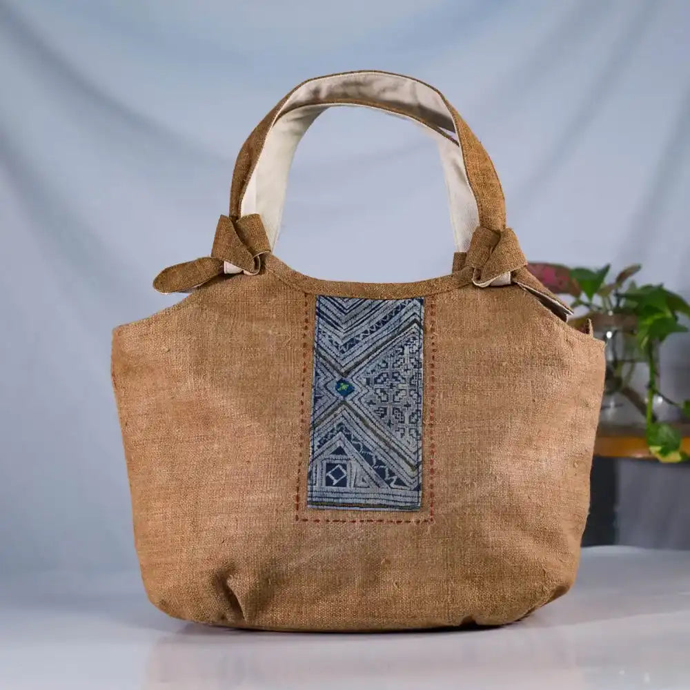 Front view of brown hemp bunny ear handbag with vintage patch, eco-friendly handmade design.