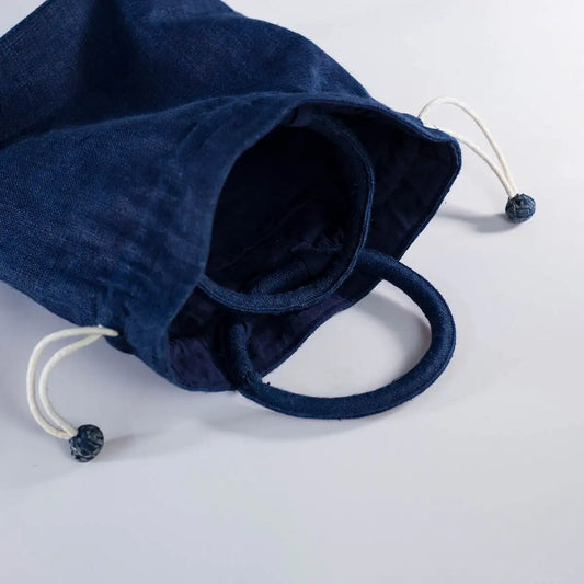 Close-up of indigo hemp bucket bag with H’mong fabric patch, sustainable and stylish