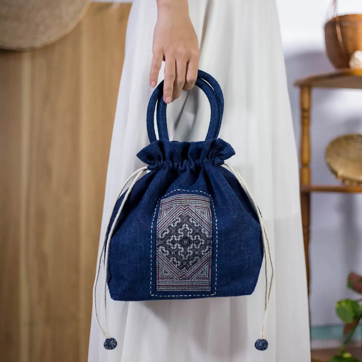 Close-up of indigo hemp bucket bag with H’mong fabric patch, sustainable and stylish