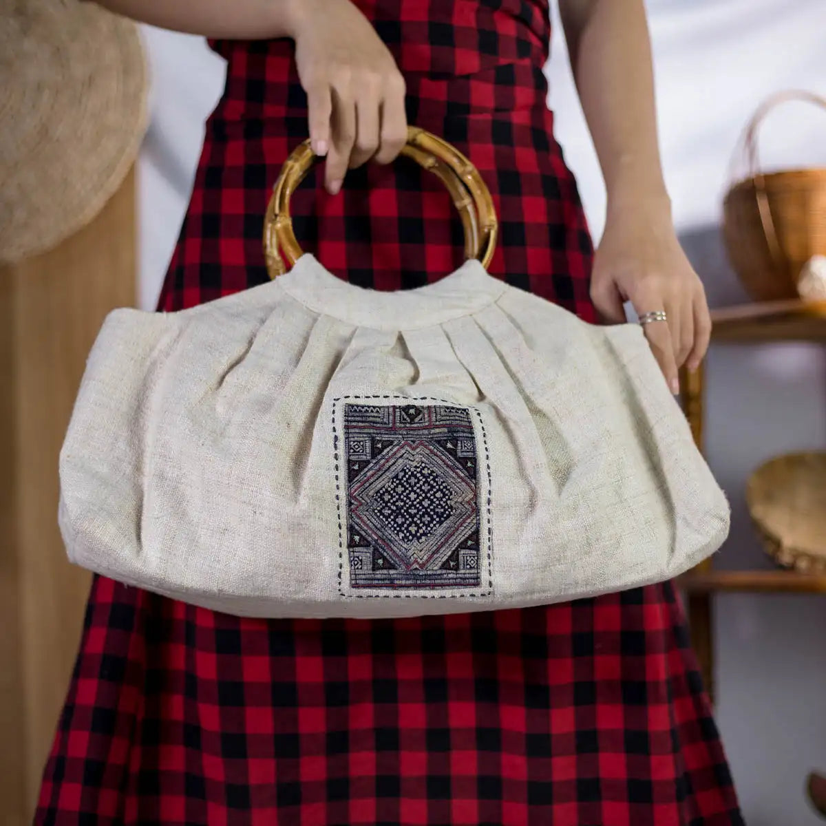Eco-friendly hemp handbag featuring bamboo handle and H’mong fabric patch, artisan-made and styled