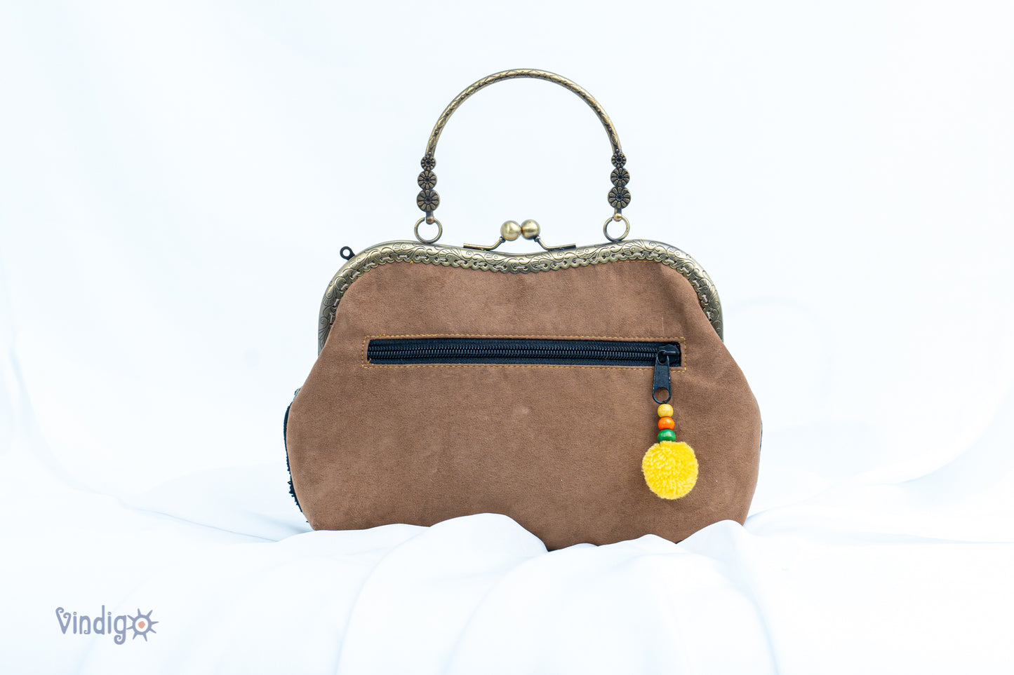 Brown faux leather bag with vintage tribal embroidery and copper-binding