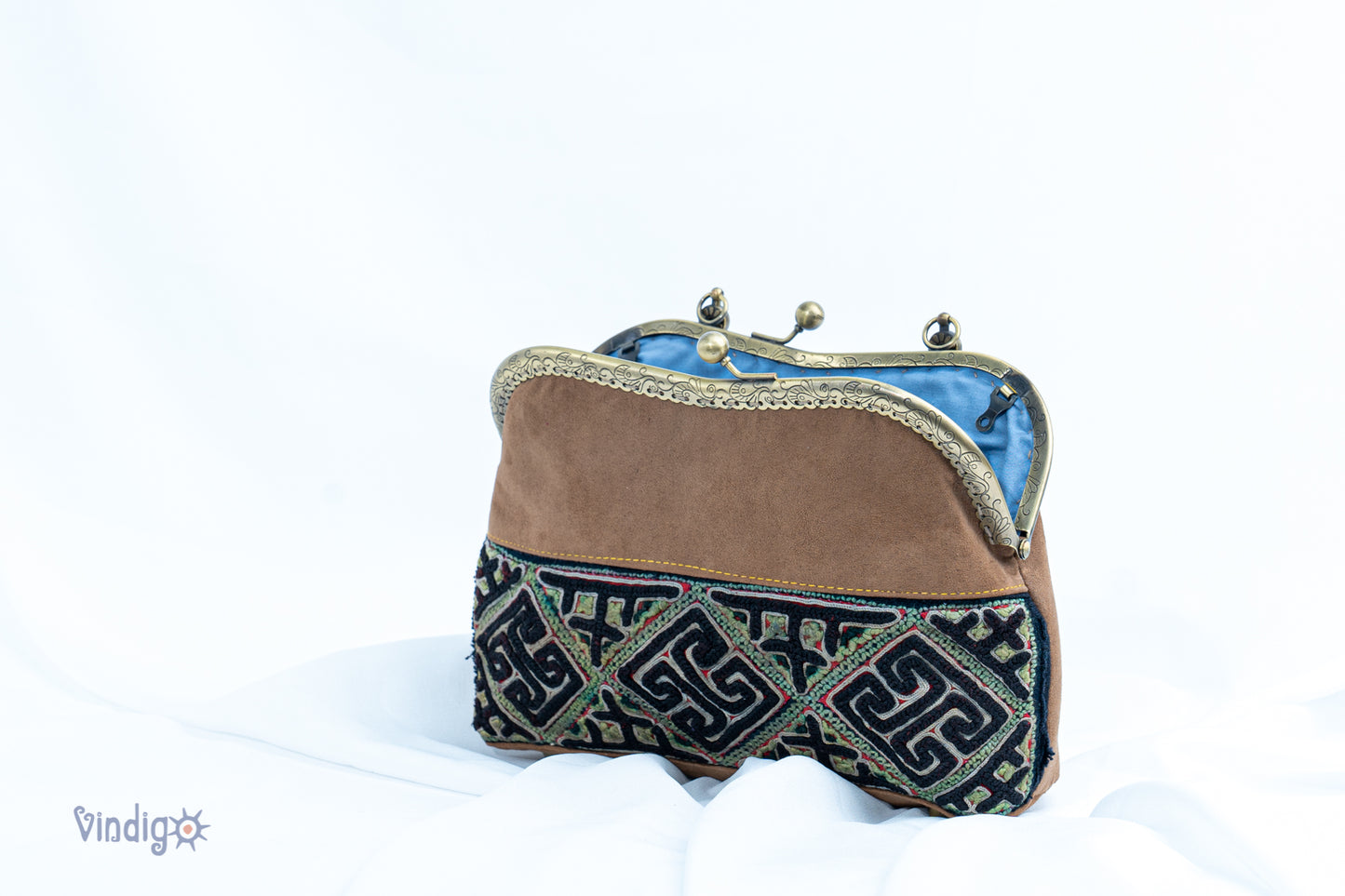 Brown faux leather bag with vintage tribal embroidery and copper-binding