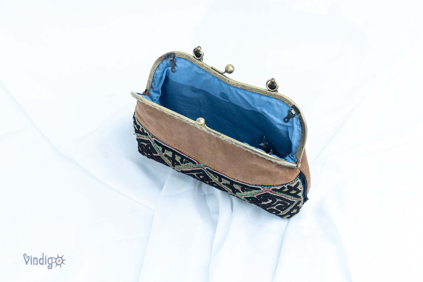 Brown faux leather bag with vintage tribal embroidery and copper-binding