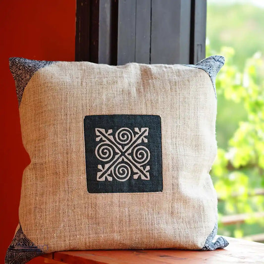 Square hemp cushion with indigo batik patch by the window
