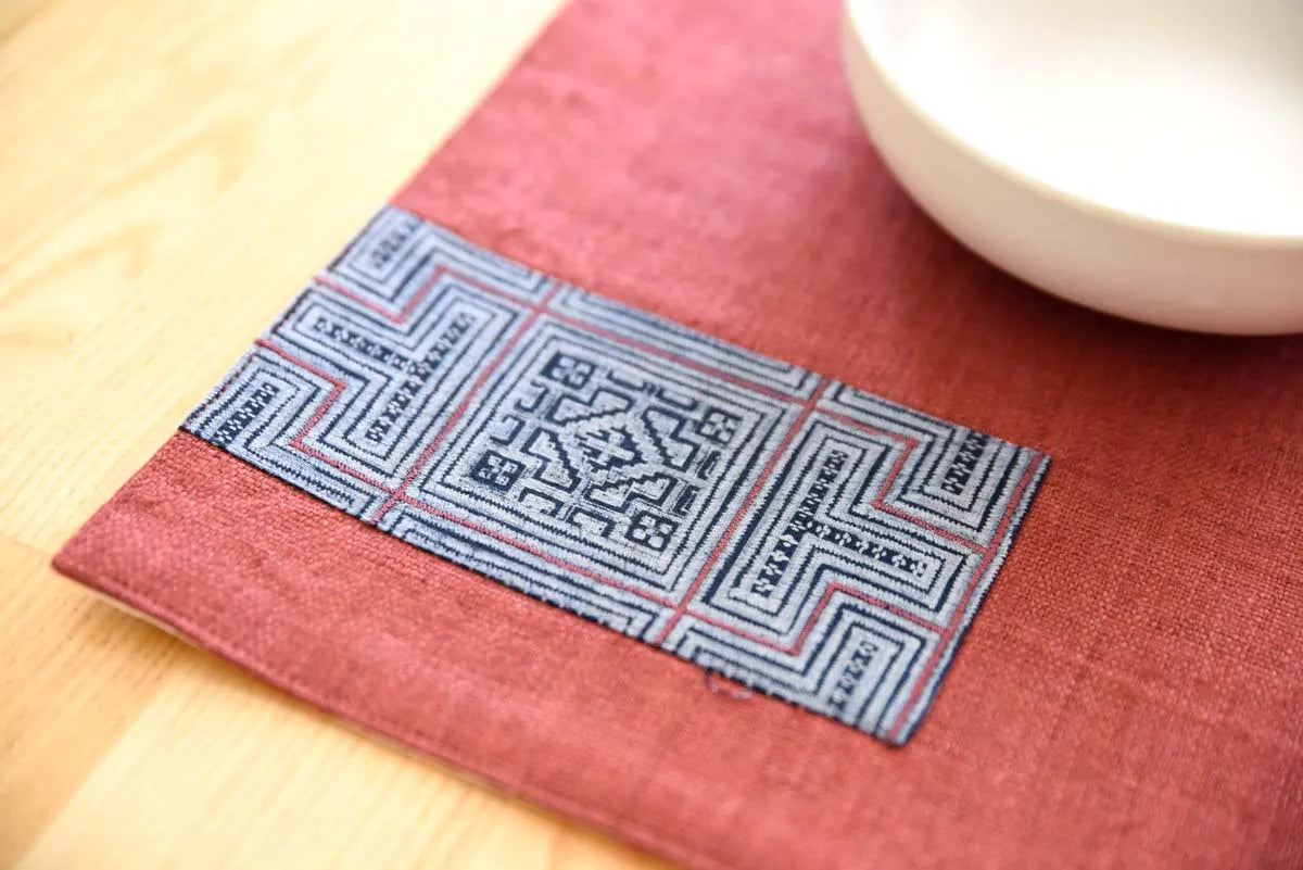 Close-up of burgundy hemp placemat with indigo fabric panel