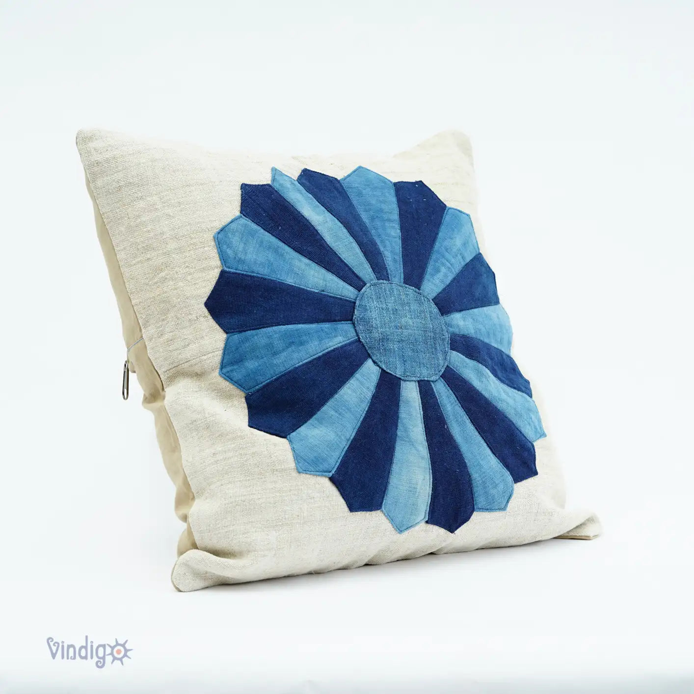 Side view of cushion cover with blue flower applique