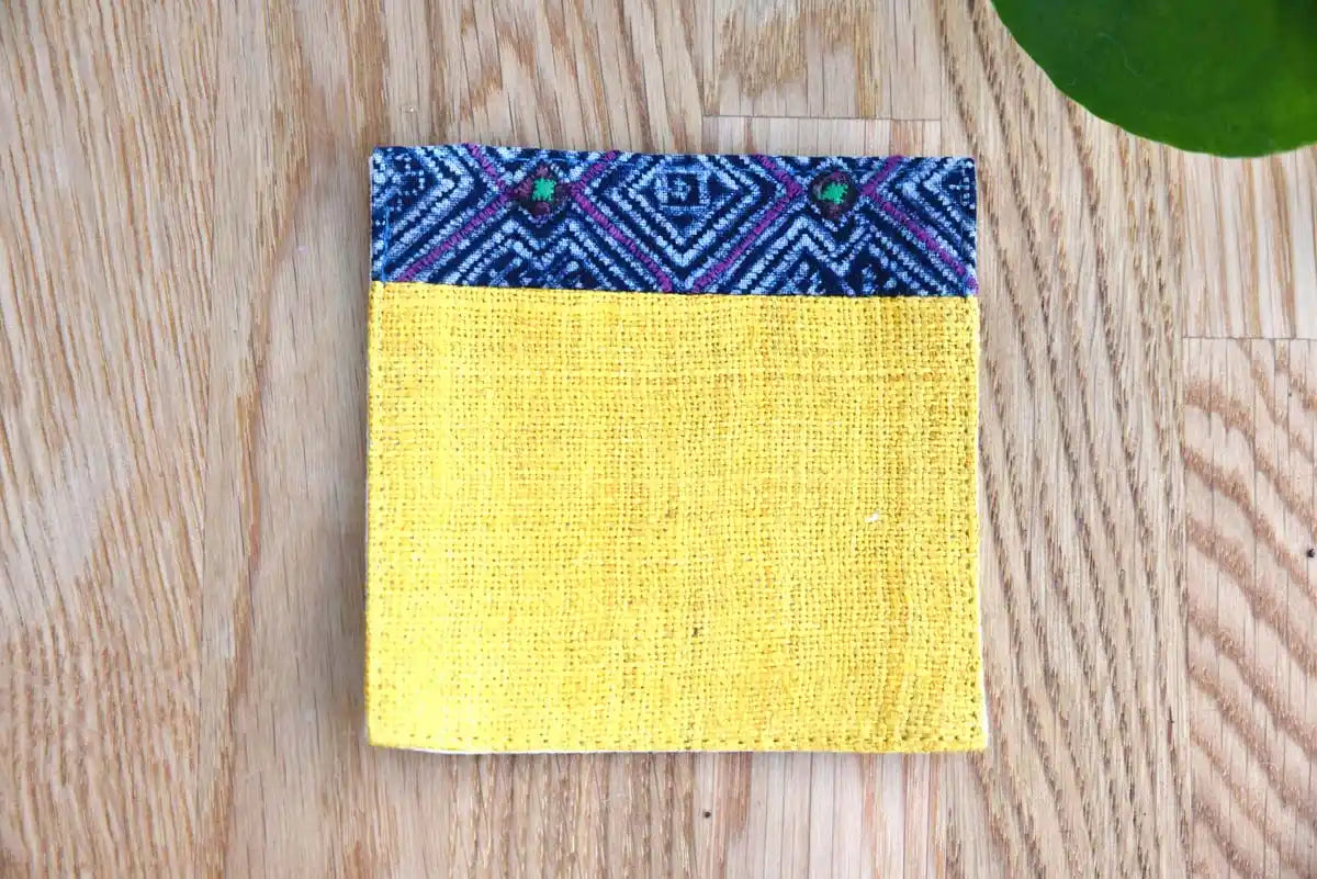 Close-up of geometric indigo pattern on yellow hemp coaster