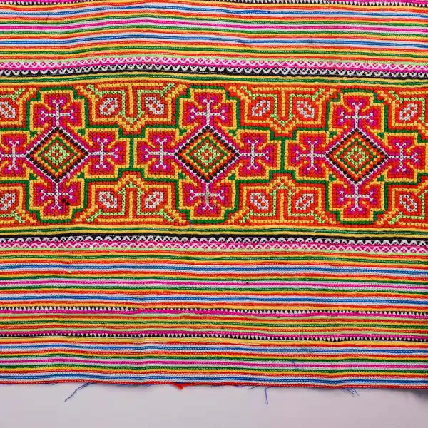 Vindigo handmade orange cotton fabric with detailed tribal embroidery close-up