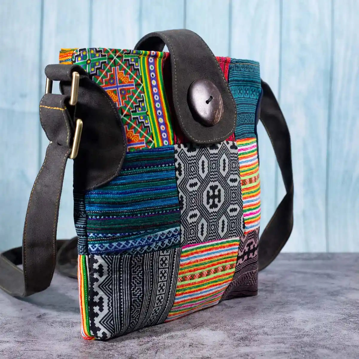 Vindigo crossbody bag side view showing faux leather strap and detailed stitching