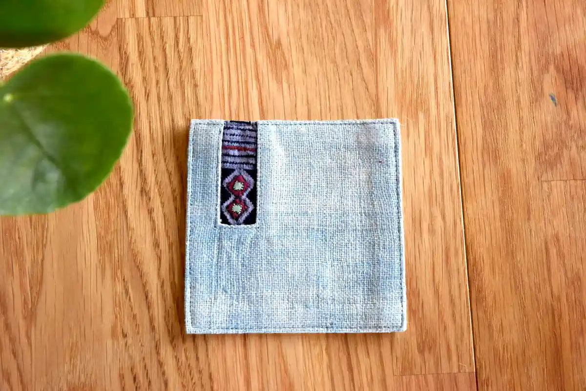 Front view of light denim coaster with colorful tribal accent