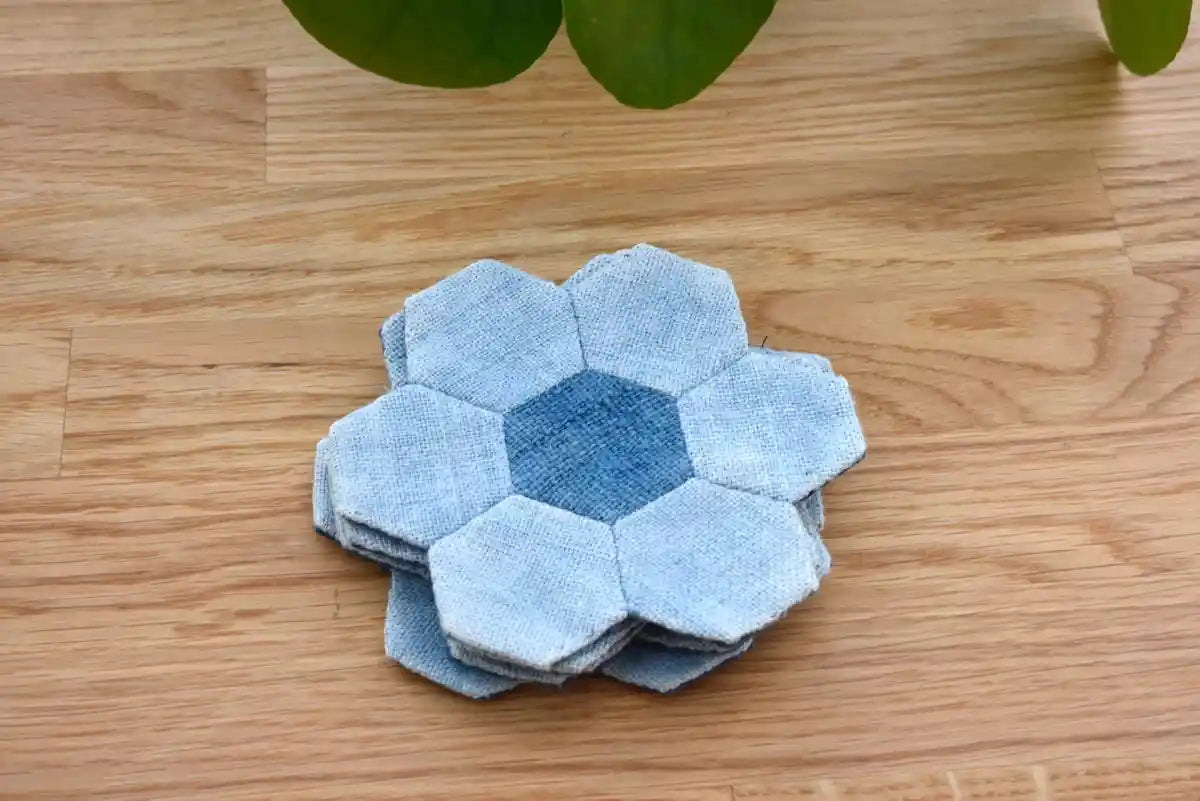 Stack of denim hexagon coasters with flower-shaped patchwork