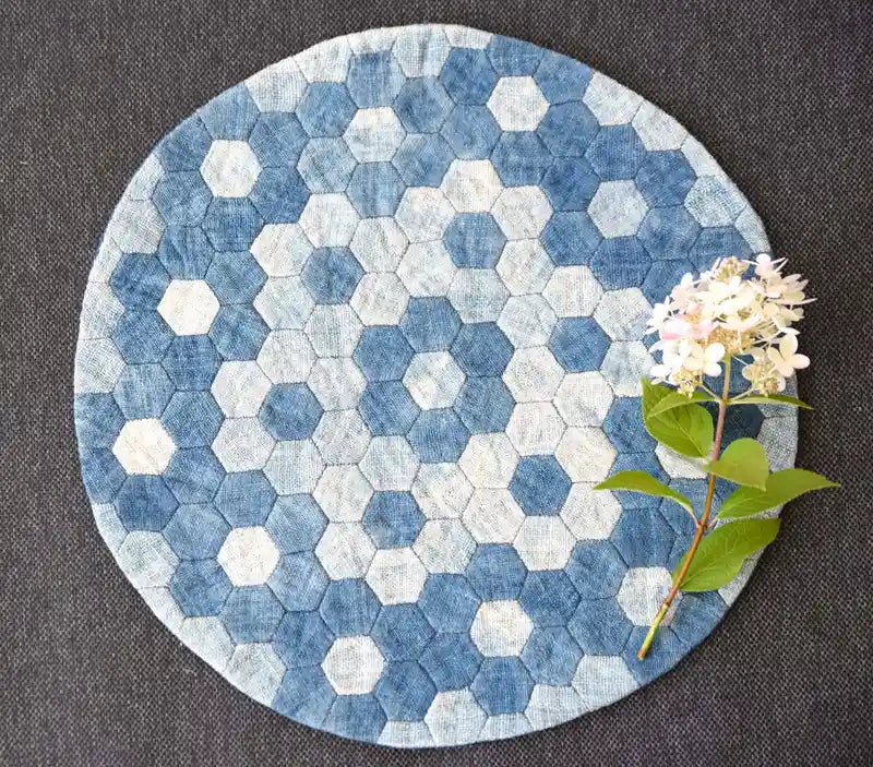 Handmade denim placemat with hexagon design and white flower