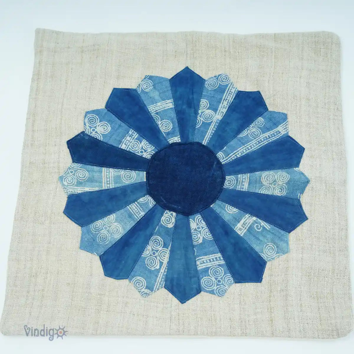 Linnekuddfodral med solformad blomdesign i olika blå batikmönster
