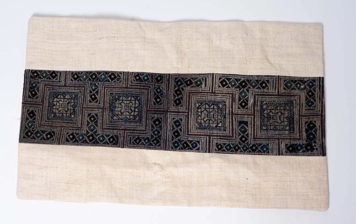 Front view of beige hemp cushion cover with indigo embroidery panel