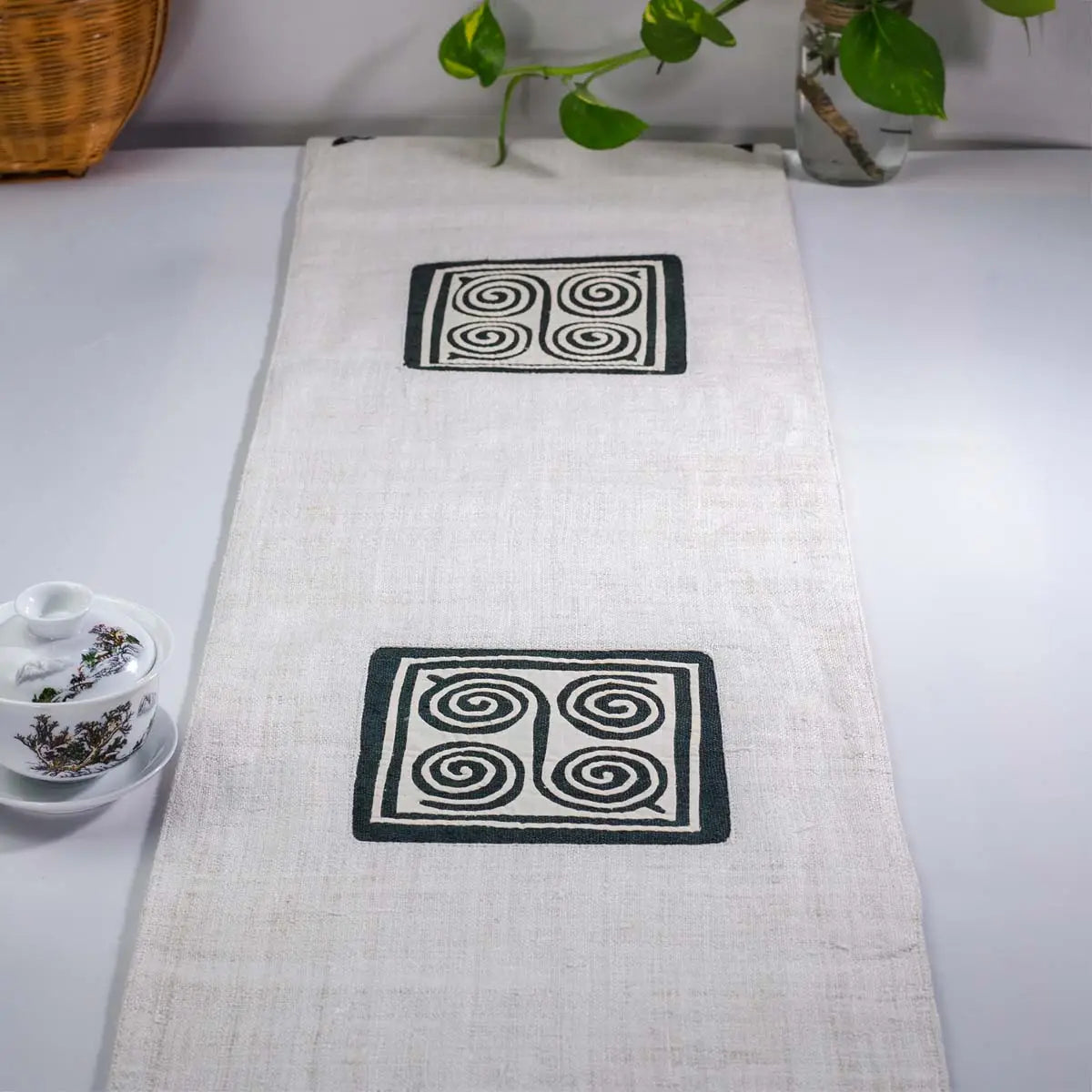 Vindigo beige hemp table runner lifestyle view featuring double H’mong spiral motifs