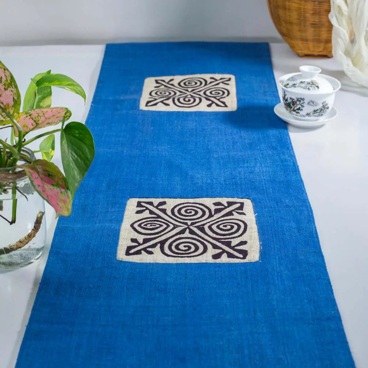 Vindigo blue hemp table runner lifestyle view with central embroidered motif