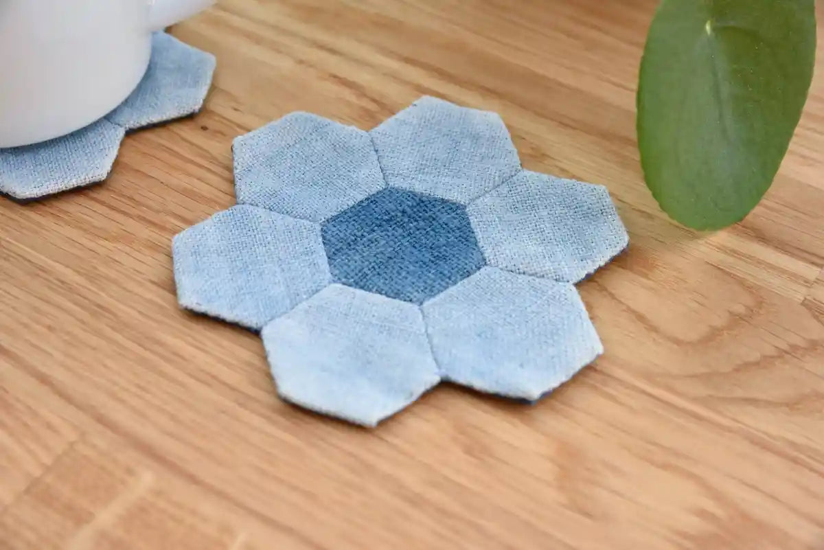 Close-up of blue denim flower coaster showing hexagon stitching