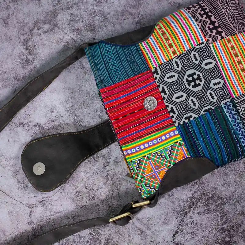 Vindigo crossbody bag flat lay showing coconut button and dark brown strap