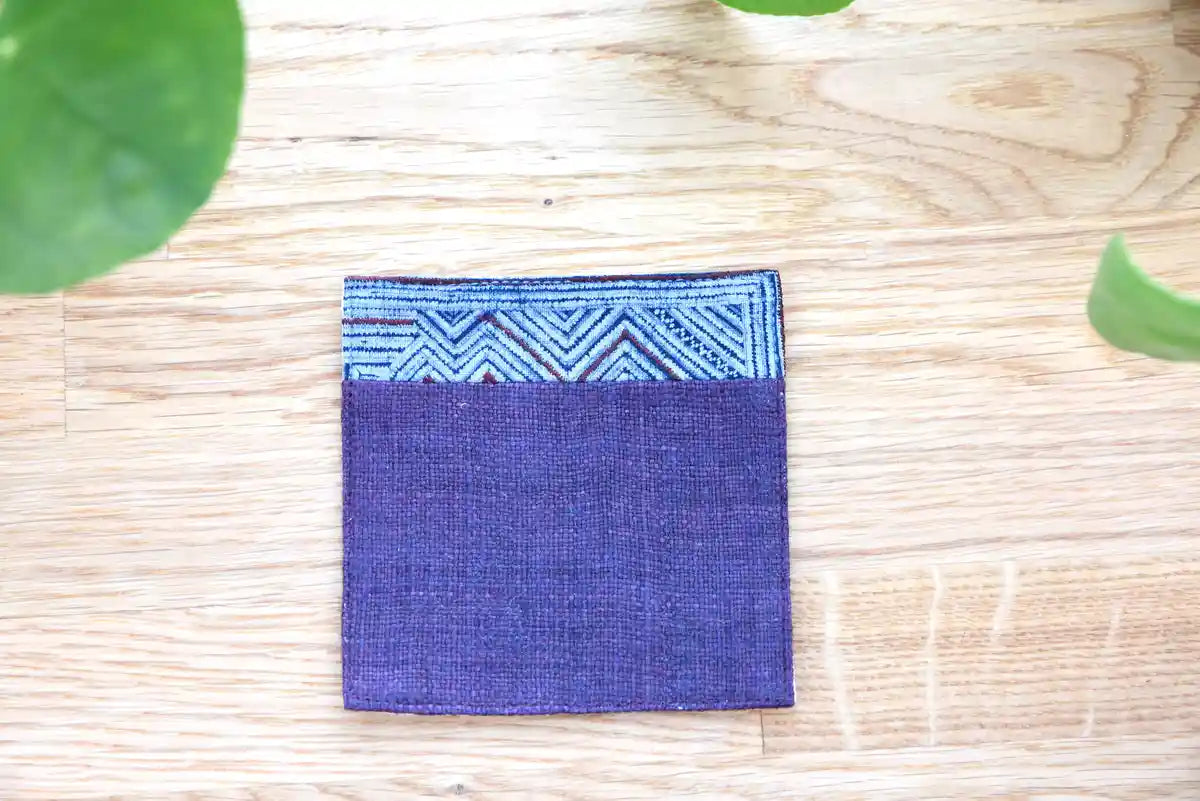 Geometric indigo pattern stitched on hemp coaster surface