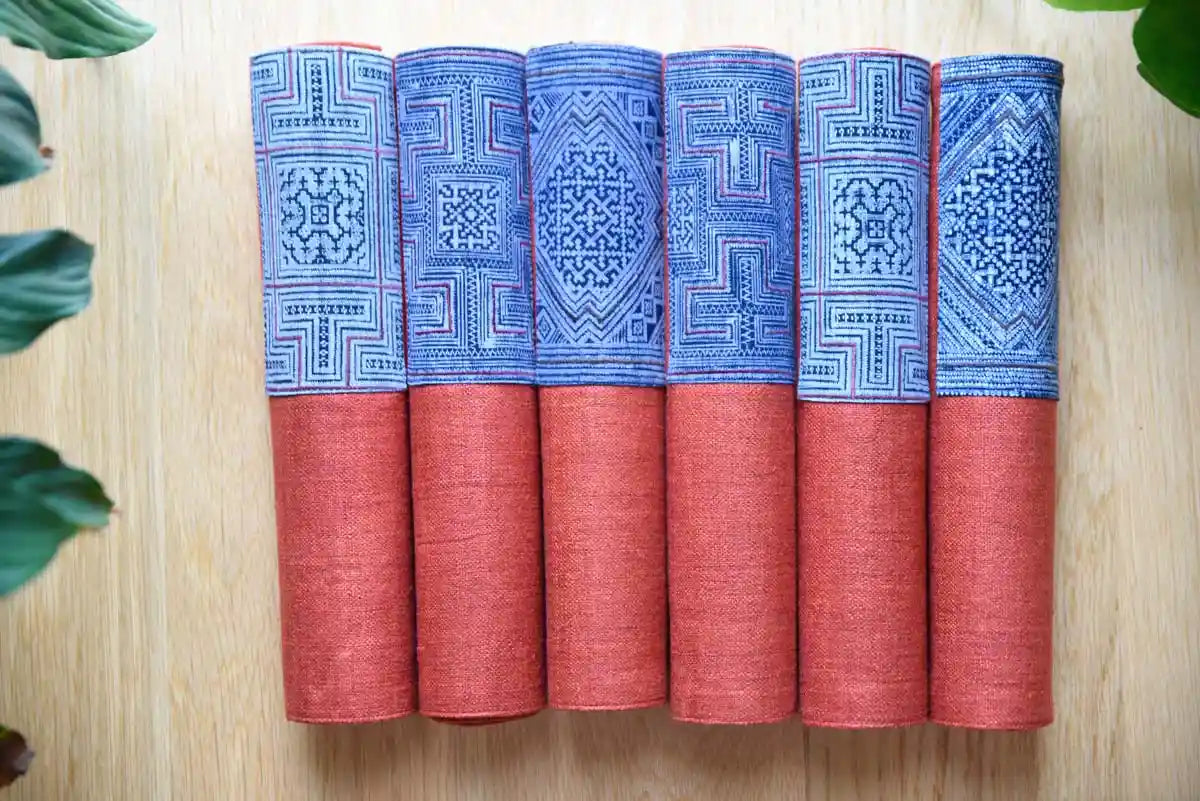 Rolled burgundy and indigo hemp napkins with geometric design