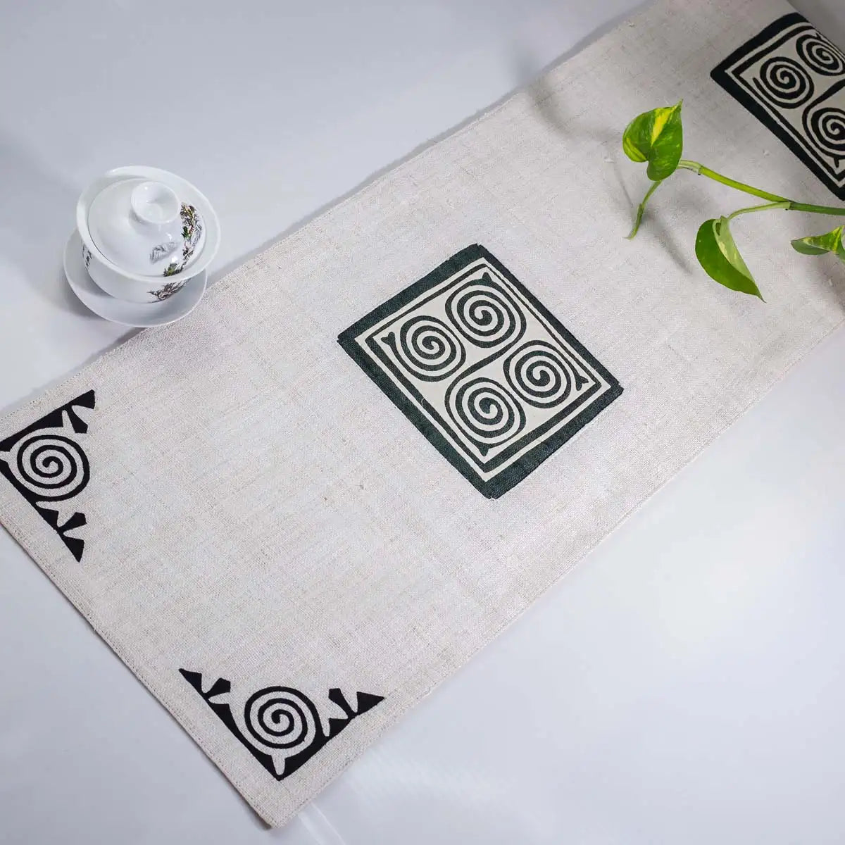 Vindigo beige hemp table runner side angle showing spiral motif and soft cotton texture