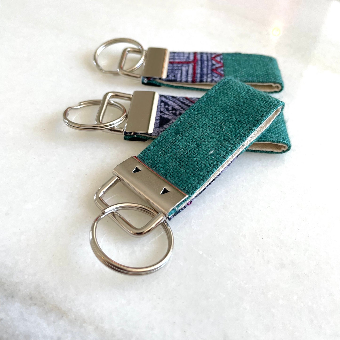 Emerald green hemp fabric keychain with vintage batik patch, stainless metal key fob