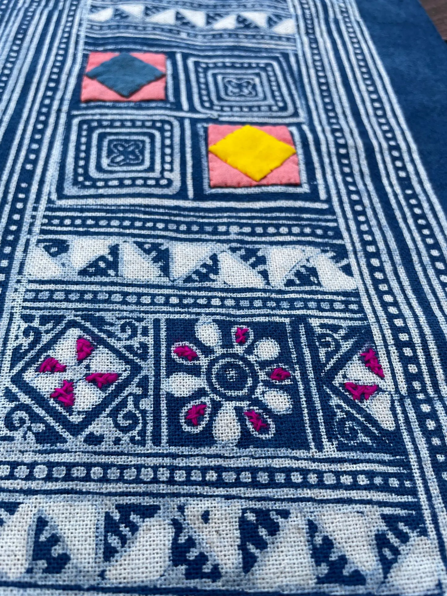 Block print batik with embroidery and appliqué on cotton in geometric flowery pattern