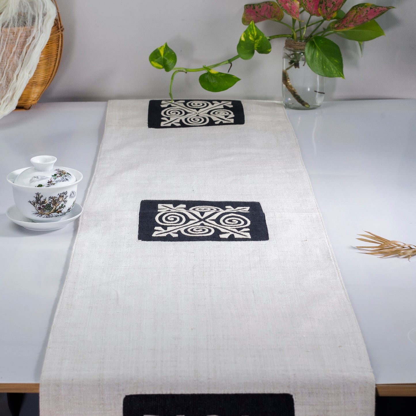 White Hemp Table Runner, patterns on black background, hand-stitched details at both ends