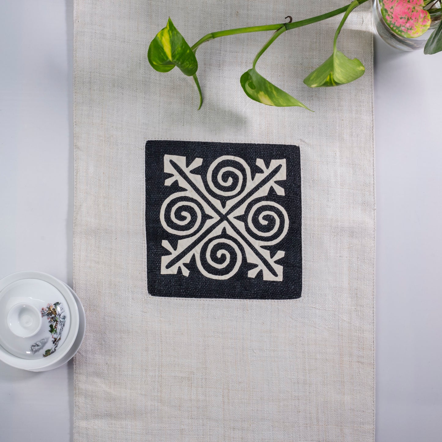 White Hemp Table Runner, patterns on black background, hand-stitched details at both ends