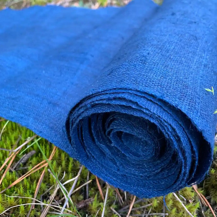Rolled-up indigo hemp fabric on a natural background