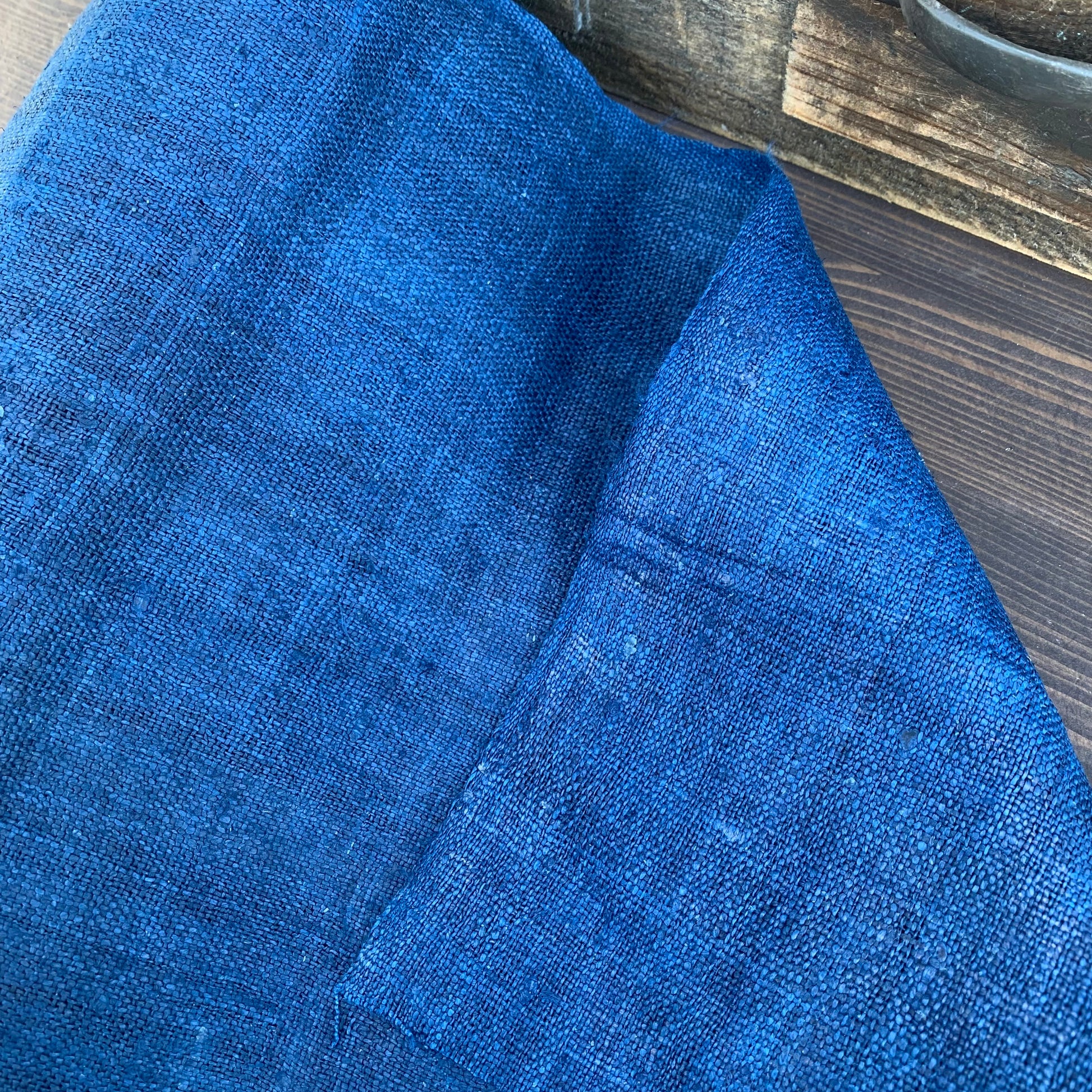 Close-up of blue fabric on a wooden surface