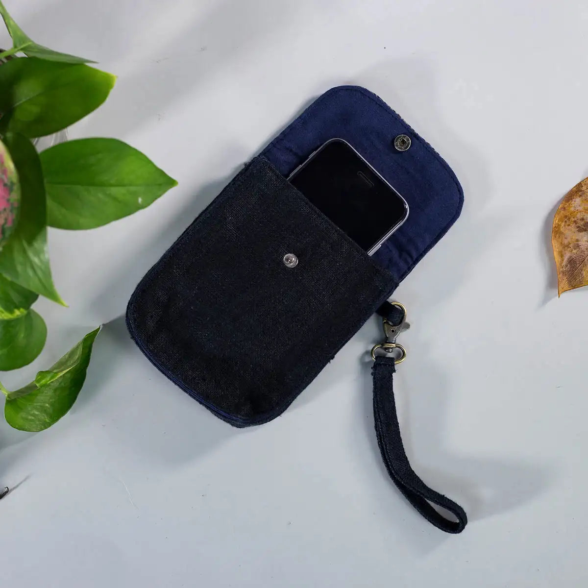 Interior view of black hemp flip phone belt bag with lining and magnetic button closure