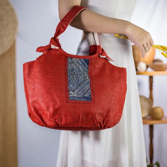 Front view of red natural hemp bunny ear handbag with vintage H’Mong patch from Purity Collection