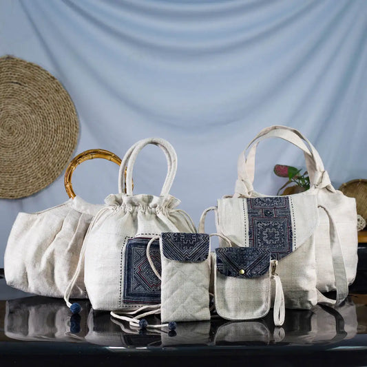 Collection of eco-friendly hemp handbags with bamboo handles and batik patch designs