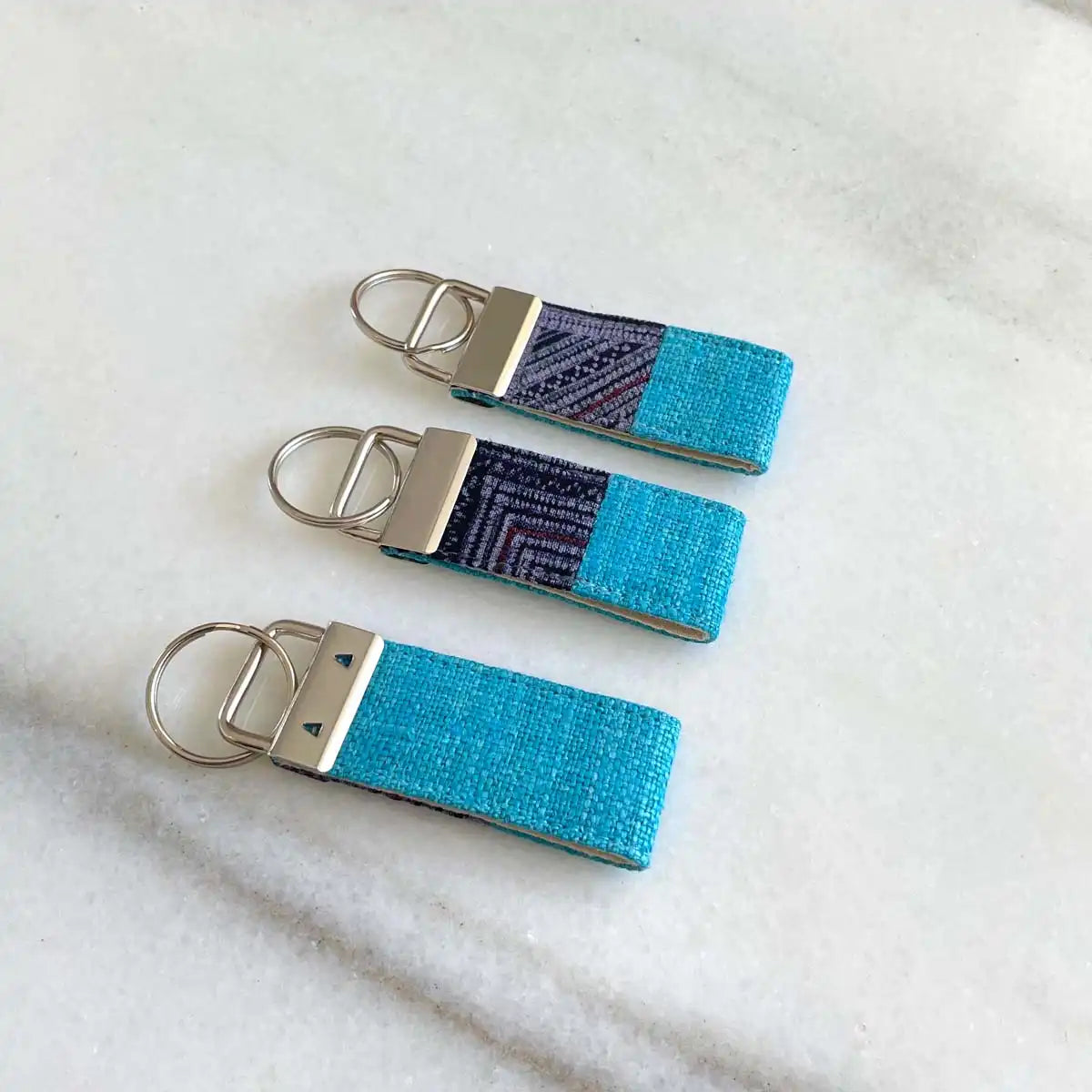 Vindigo keychain blue embroidered front plain back view
